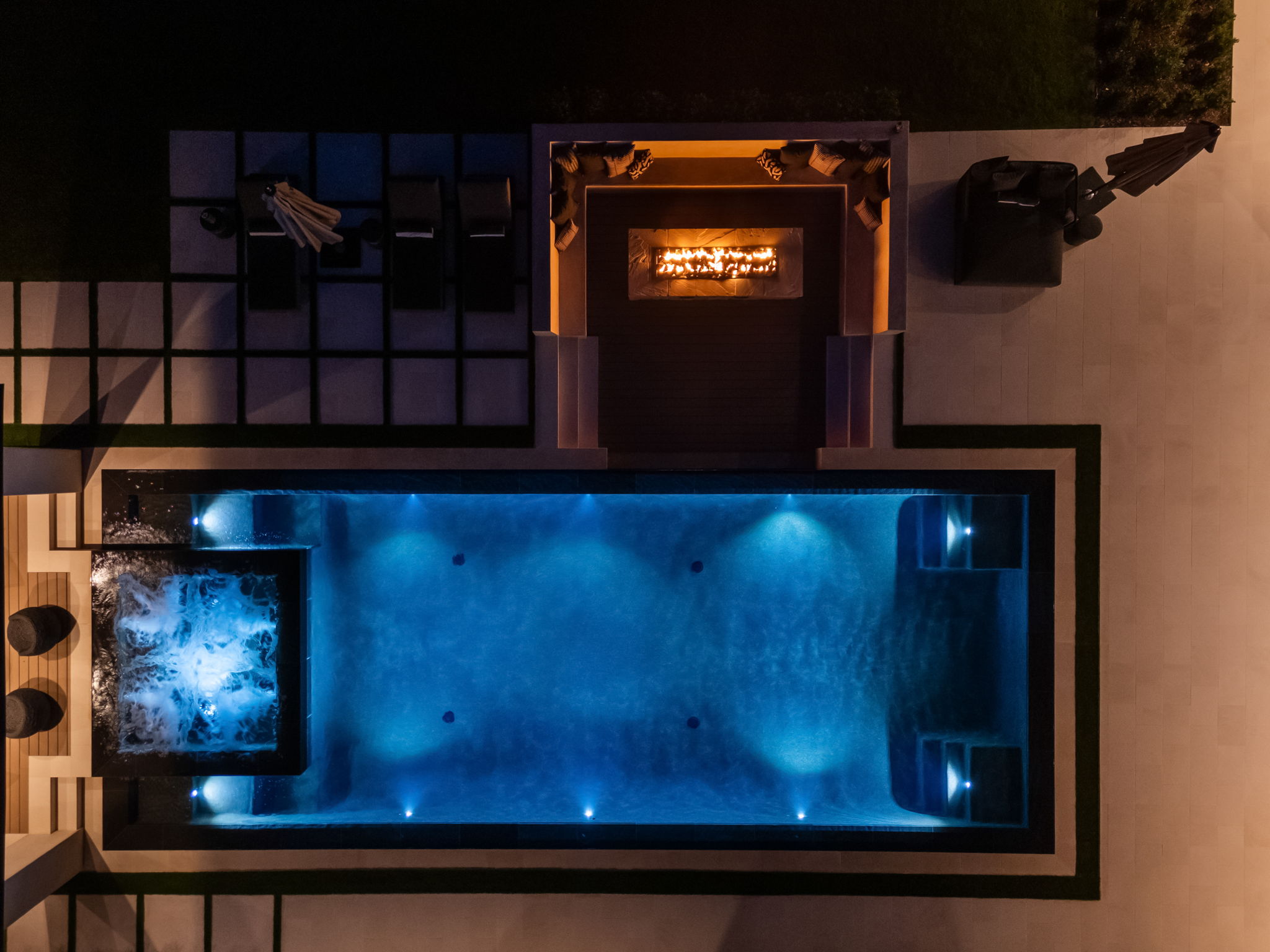 Aerial twilight drone photo of a lit infinity pool and spa — San Diego real estate drone media by YonoPro