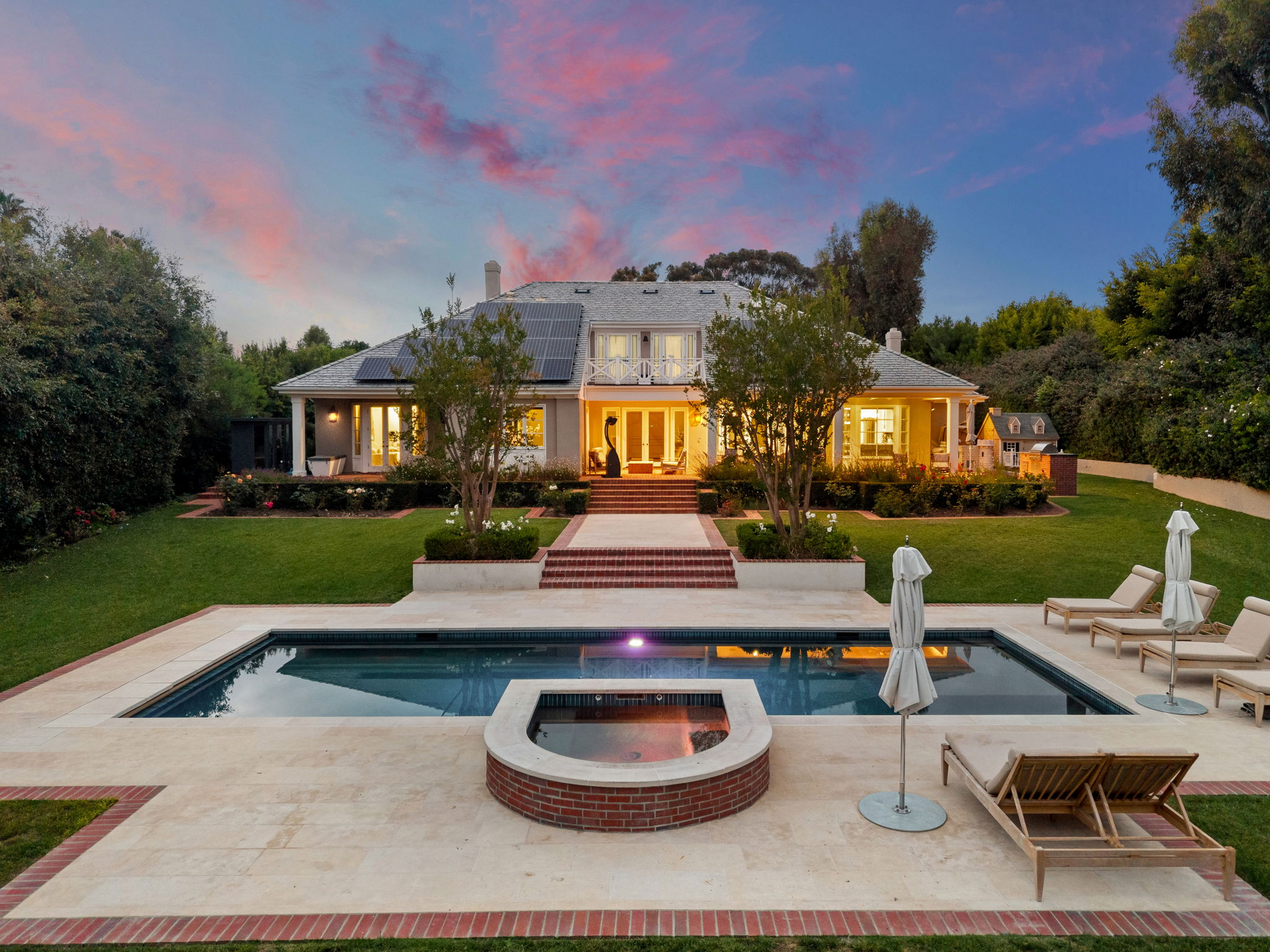 Luxury San Diego estate at twilight — infinity pool, lit pavilion, firepit terrace shot by YonoPro
