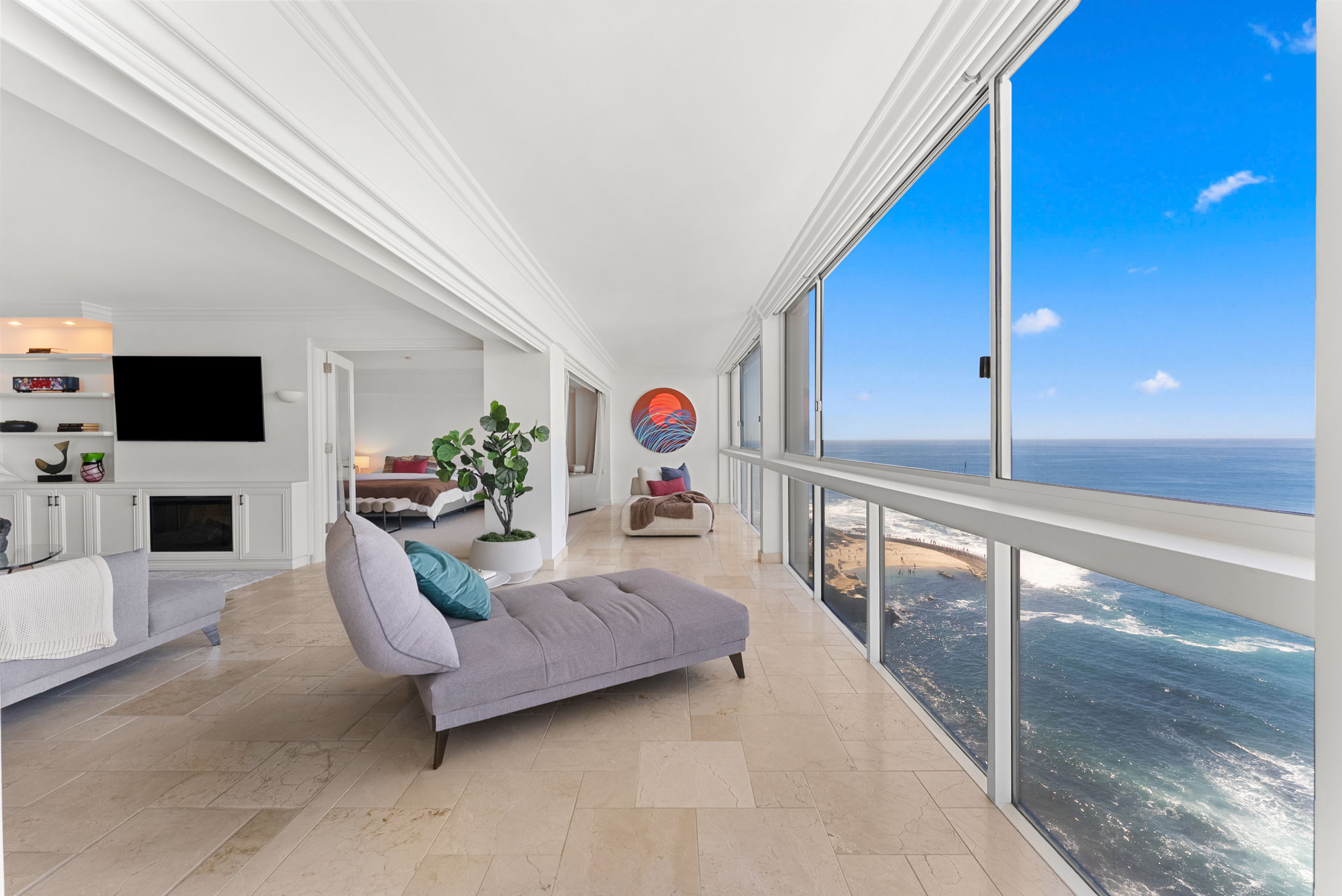 Oceanfront primary suite with panoramic coastline views and fireplace — San Diego real estate photography by YonoPro