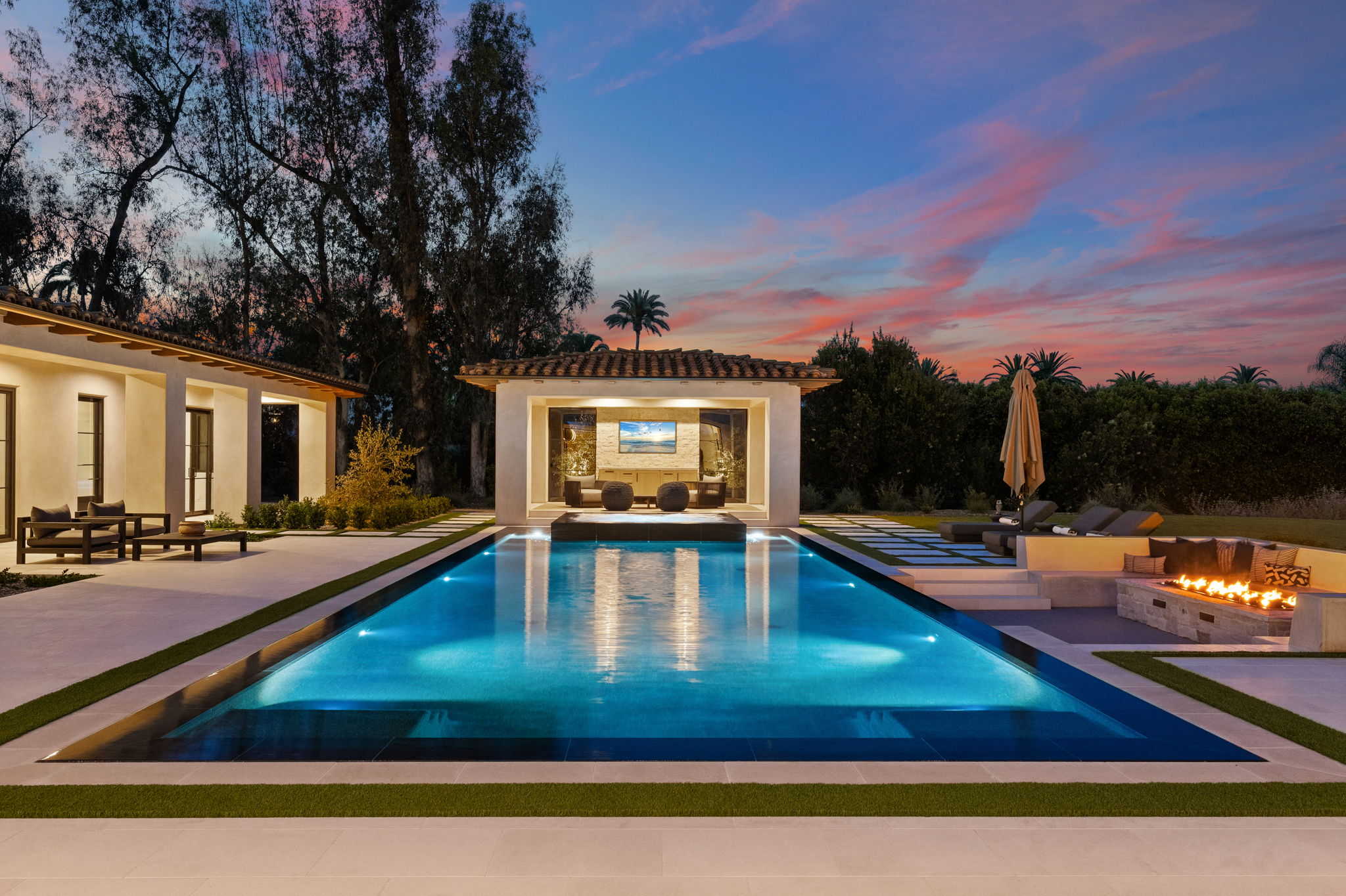 Twilight pool and pool house under a sunset sky — San Diego twilight real estate photography by YonoPro